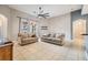 Spacious living room with a ceiling fan and ample natural light at 13029 Haverhill Dr, Spring Hill, FL 34609