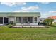 Ground level exterior view of condo with paved patio at 1802 Bedford Ln # 13, Sun City Center, FL 33573