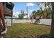 Spacious backyard with grassy area and playground set at 1866 Michigan Ne Ave, St Petersburg, FL 33703