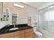 Clean bathroom with black countertops and a shower/tub combo at 1866 Michigan Ne Ave, St Petersburg, FL 33703