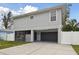 Two-story house with gray siding, gray garage door, and a blue front door at 1866 Michigan Ne Ave, St Petersburg, FL 33703