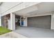 Gray house with a blue door, screened porch, and a gray garage at 1866 Michigan Ne Ave, St Petersburg, FL 33703
