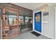Screened porch with blue door and a bench at 1866 Michigan Ne Ave, St Petersburg, FL 33703