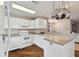 White kitchen features stainless steel appliances and wood floors at 1866 Michigan Ne Ave, St Petersburg, FL 33703