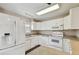 White kitchen with stainless steel appliances and granite countertops at 1866 Michigan Ne Ave, St Petersburg, FL 33703