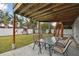 Covered patio with outdoor dining set and stairs at 1866 Michigan Ne Ave, St Petersburg, FL 33703
