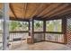 Screened porch with wood flooring and access to backyard at 1866 Michigan Ne Ave, St Petersburg, FL 33703