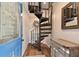 Modern spiral staircase in entryway with wood steps and metal railing at 1866 Michigan Ne Ave, St Petersburg, FL 33703