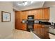 Updated kitchen, wood cabinets, granite counters, and black appliances at 275 Bayshore Blvd # 408, Tampa, FL 33606