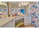 Bathroom with double vanity, shower, and floral shower curtain at 2773 Via Cipriani # 1321B, Clearwater, FL 33764