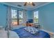 Bright bedroom with two windows, a bed, and a work desk at 2773 Via Cipriani # 1321B, Clearwater, FL 33764