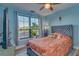 Bright bedroom with large window, plush bedding, and ceiling fan at 2773 Via Cipriani # 1321B, Clearwater, FL 33764