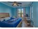 Bedroom with wooden bed frame, large window, and ceiling fan at 2773 Via Cipriani # 1321B, Clearwater, FL 33764