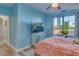 Bedroom with large window, TV, and a ceiling fan at 2773 Via Cipriani # 1321B, Clearwater, FL 33764