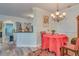 Bright dining room with red tablecloth and chandelier at 2773 Via Cipriani # 1321B, Clearwater, FL 33764