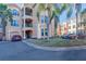 Two-story condo building with attached garages and lush landscaping at 2773 Via Cipriani # 1321B, Clearwater, FL 33764