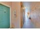 Interior hallway with teal doors and light beige walls at 2773 Via Cipriani # 1321B, Clearwater, FL 33764