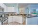 White kitchen cabinets, granite countertops, and stainless steel appliances at 2773 Via Cipriani # 1321B, Clearwater, FL 33764