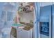 Compact laundry room with washer, dryer, and shelving at 2773 Via Cipriani # 1321B, Clearwater, FL 33764