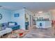 Open concept living room and kitchen with light blue walls and hardwood floors at 2773 Via Cipriani # 1321B, Clearwater, FL 33764