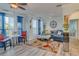 Living room with blue sectional sofa, coffee table and large windows at 2773 Via Cipriani # 1321B, Clearwater, FL 33764