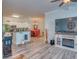 Open concept living room and kitchen with hardwood floors and fireplace at 2773 Via Cipriani # 1321B, Clearwater, FL 33764
