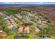 Aerial view highlighting a house's private setting near a pond at 2867 Grey Oaks Blvd, Tarpon Springs, FL 34688