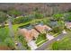 Aerial view of a luxurious home with a pool in a gated community at 2867 Grey Oaks Blvd, Tarpon Springs, FL 34688