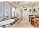 Luxurious bathroom with soaking tub, walk-in shower, and double vanity at 2867 Grey Oaks Blvd, Tarpon Springs, FL 34688
