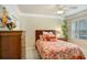 Cozy bedroom with queen-size bed and plantation shutters at 2867 Grey Oaks Blvd, Tarpon Springs, FL 34688