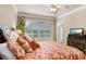 Bright bedroom with a comfortable bed and plantation shutters at 2867 Grey Oaks Blvd, Tarpon Springs, FL 34688