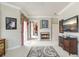 Comfortable bedroom with fireplace and access to balcony at 2867 Grey Oaks Blvd, Tarpon Springs, FL 34688