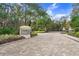 Gated community entrance with stonework and landscaping at 2867 Grey Oaks Blvd, Tarpon Springs, FL 34688