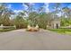 Grey Oaks community entrance, featuring a stone arch and lush greenery at 2867 Grey Oaks Blvd, Tarpon Springs, FL 34688