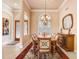 Elegant dining room features a large table, chandelier, and hardwood floors at 2867 Grey Oaks Blvd, Tarpon Springs, FL 34688
