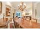 Bright dining room with a large table, chandelier, and access to the backyard at 2867 Grey Oaks Blvd, Tarpon Springs, FL 34688