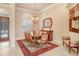 Elegant dining room with a large table and chandelier at 2867 Grey Oaks Blvd, Tarpon Springs, FL 34688