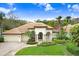 Beautiful home with tile roof, manicured lawn, and two-car garage at 2867 Grey Oaks Blvd, Tarpon Springs, FL 34688