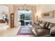 Comfortable Gathering room boasts a leather sectional and sliding doors to a patio at 2867 Grey Oaks Blvd, Tarpon Springs, FL 34688