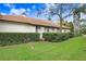House exterior with manicured lawn and hedges at 2867 Grey Oaks Blvd, Tarpon Springs, FL 34688