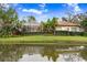 House exterior with canal view and lush landscaping at 2867 Grey Oaks Blvd, Tarpon Springs, FL 34688