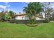 One-story house with manicured lawn and tropical landscaping at 2867 Grey Oaks Blvd, Tarpon Springs, FL 34688