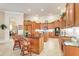 Spacious kitchen with an island, granite countertops, and wood cabinets at 2867 Grey Oaks Blvd, Tarpon Springs, FL 34688