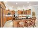 Modern kitchen with island, granite countertops, and wood cabinets at 2867 Grey Oaks Blvd, Tarpon Springs, FL 34688