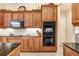Modern kitchen with double oven and granite countertops at 2867 Grey Oaks Blvd, Tarpon Springs, FL 34688