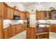 Updated kitchen with an island, granite countertops, and ample cabinetry at 2867 Grey Oaks Blvd, Tarpon Springs, FL 34688