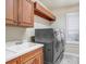 Laundry room with washer, dryer, and cabinets at 2867 Grey Oaks Blvd, Tarpon Springs, FL 34688