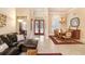 Open living space with leather sectional and dining area at 2867 Grey Oaks Blvd, Tarpon Springs, FL 34688