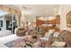 Open living room with comfortable seating and views of the kitchen at 2867 Grey Oaks Blvd, Tarpon Springs, FL 34688