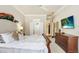 Comfortable main bedroom with plush bedding and large windows at 2867 Grey Oaks Blvd, Tarpon Springs, FL 34688
